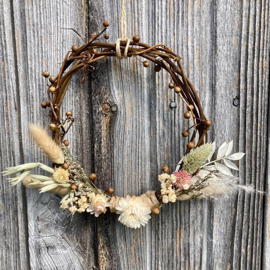 Handcrafted decorative wreath made with dried flowers, grasses and vines by Sassafras Hill